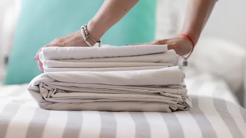 a woman folding sheets