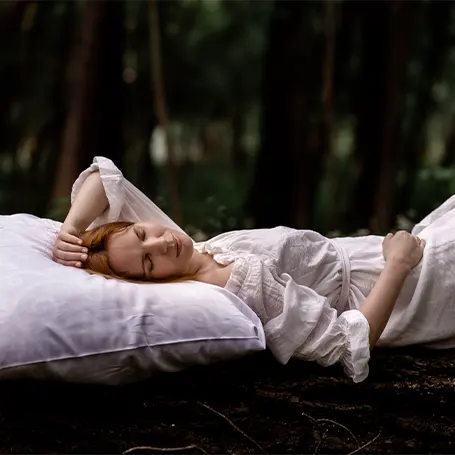 An image of a woman sleeping in nature