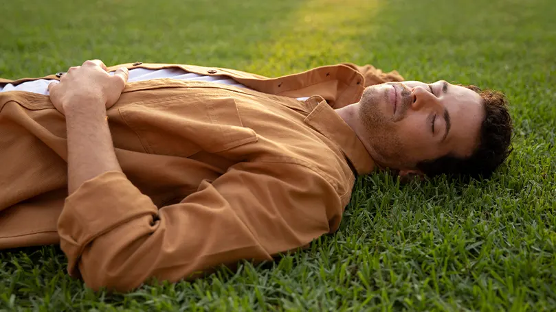 a man sleeping on grass