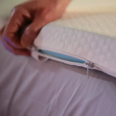 unzipping the removable bamboo cover on panda's mattress topper