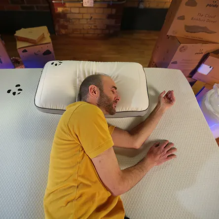 our reviewer testing sleeping positions on a panda mattress topper