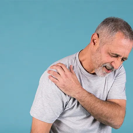 An image of a man with arthritis pain in their shoulder