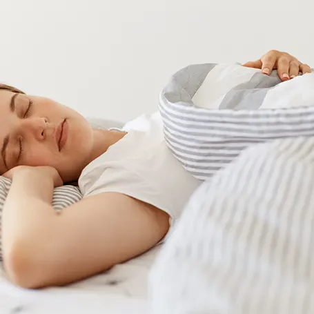 An image of a woman sleeping on a mattress with good back support