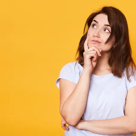 A woman thinking of what to consider when shopping for a latex mattress