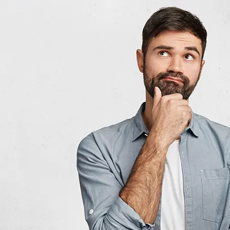 An image of a man stroking his chin and wondering something