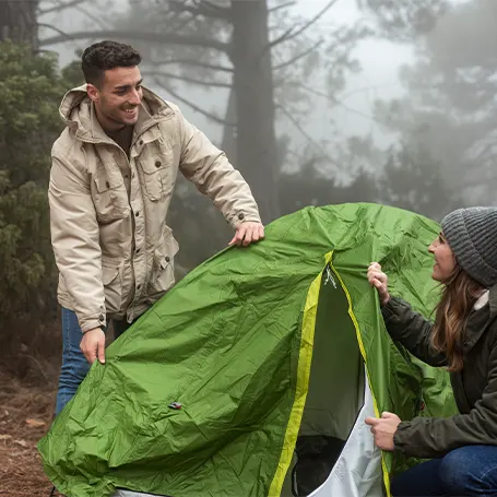 An image of two people setting up their tent