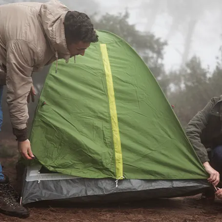An image of a couple setting up a waterproof tent