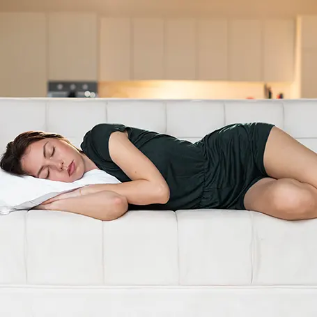 An image of a woman sleeping on her side