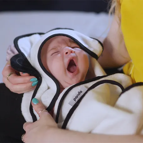 Baby in a hooded towel.