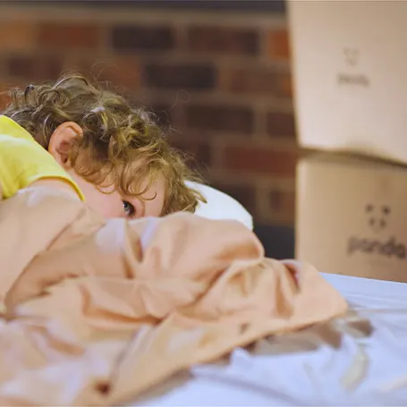 Child snuggled into Panda bedding.