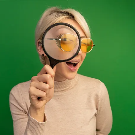 An image of a woman with a magnifying glass
