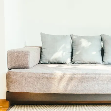 An image of a sofa with a few pillows on top