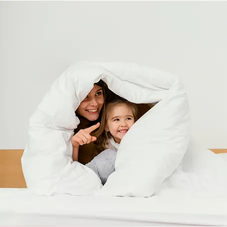 An image of a mother and her child hiding inside an anti allergy duvet