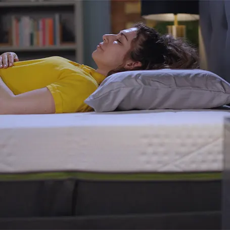 Person lying on their back on the Emma mattress.