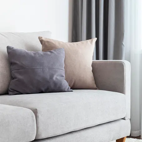 An image of a new sofa bed with two pillows
