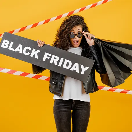 An image of a woman holding a Black Friday sign