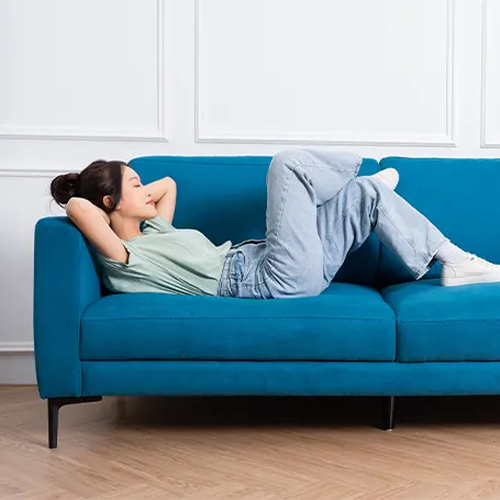 An image of a woman on a sofa bed