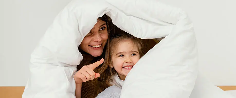 Mom and daughter in duvet
