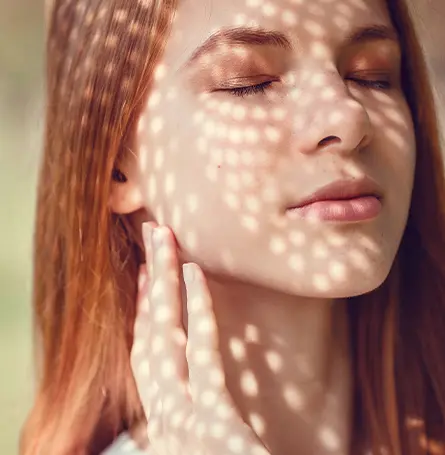An image of a woman with light shinning on her face