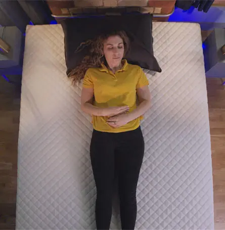 Reviewer lying on the Premium Hybrid Mattress as a back sleeper.