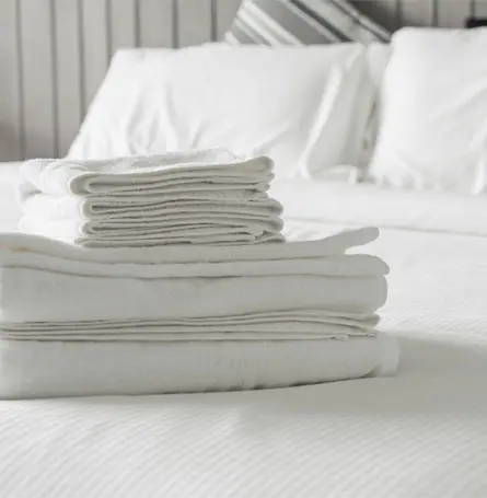 An image of recently washed sheets stacked and folded
