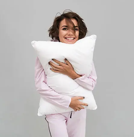 An image of a person hugging a synthetic pillow